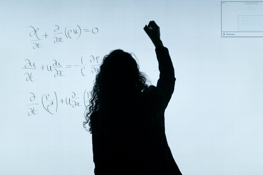 Is DVC worth it? Found out how to do your own calculations (image of a woman doing calculations on a white board)